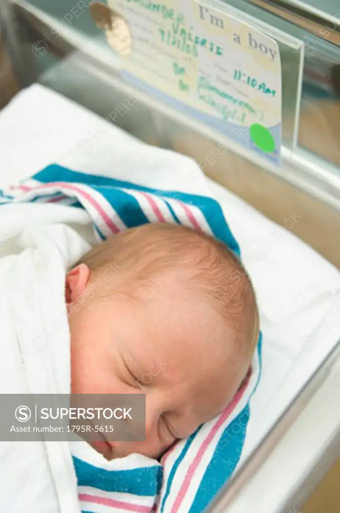 Newborn baby in hospital bed