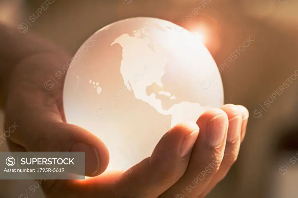Close-up of man holding glass globe