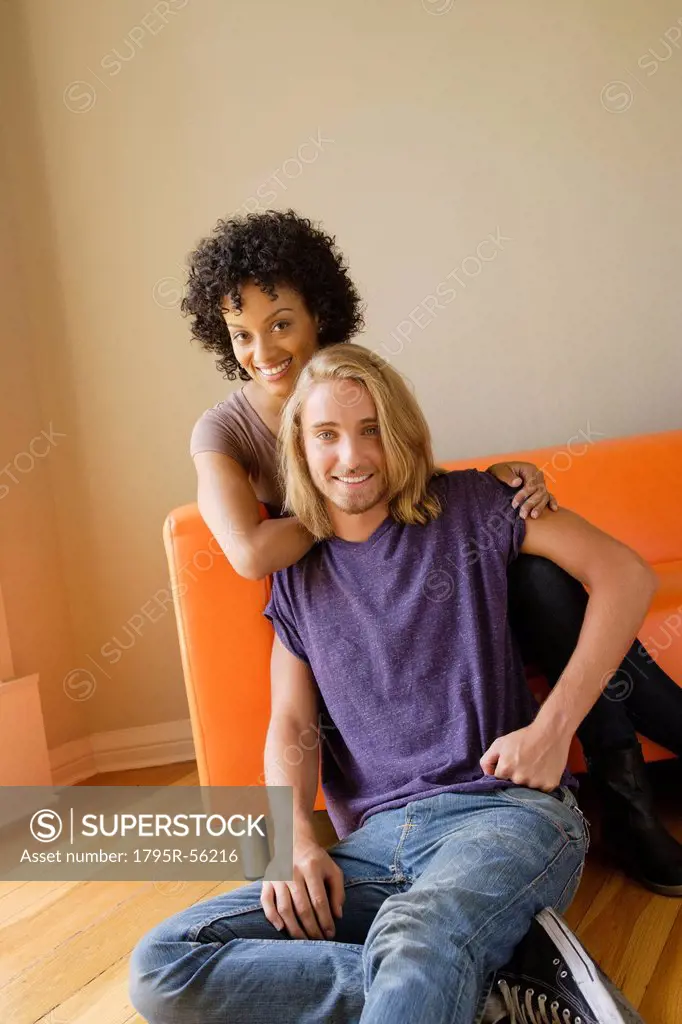 Portrait of young couple in living room