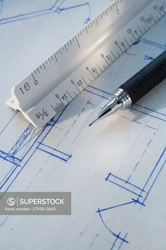Close-up of ruler and pen on blueprints