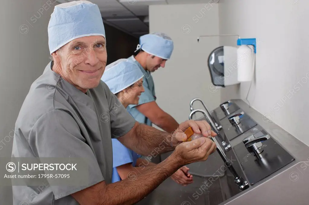 Surgeons washing hands in hospital