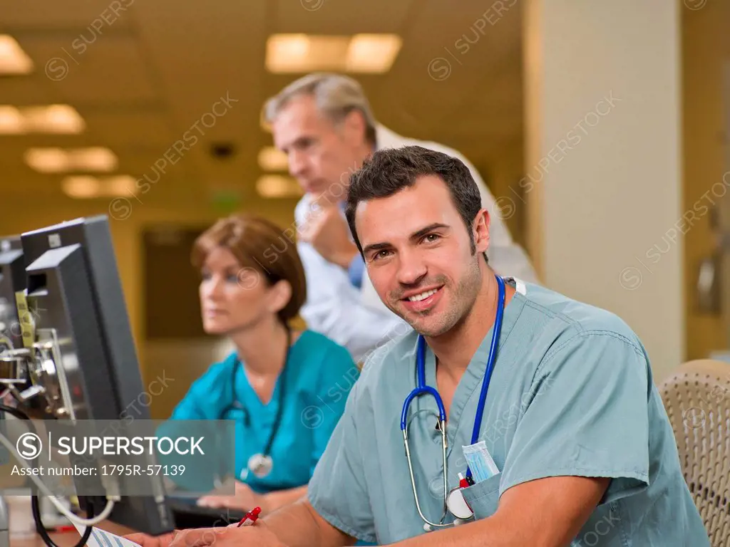 Doctor and surgeons working on computers in hospital