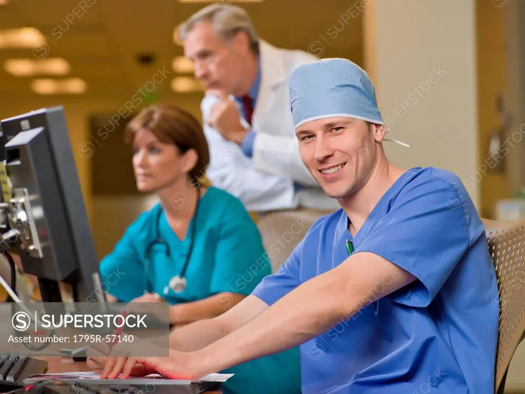 Doctor and surgeons working on computers in hospital