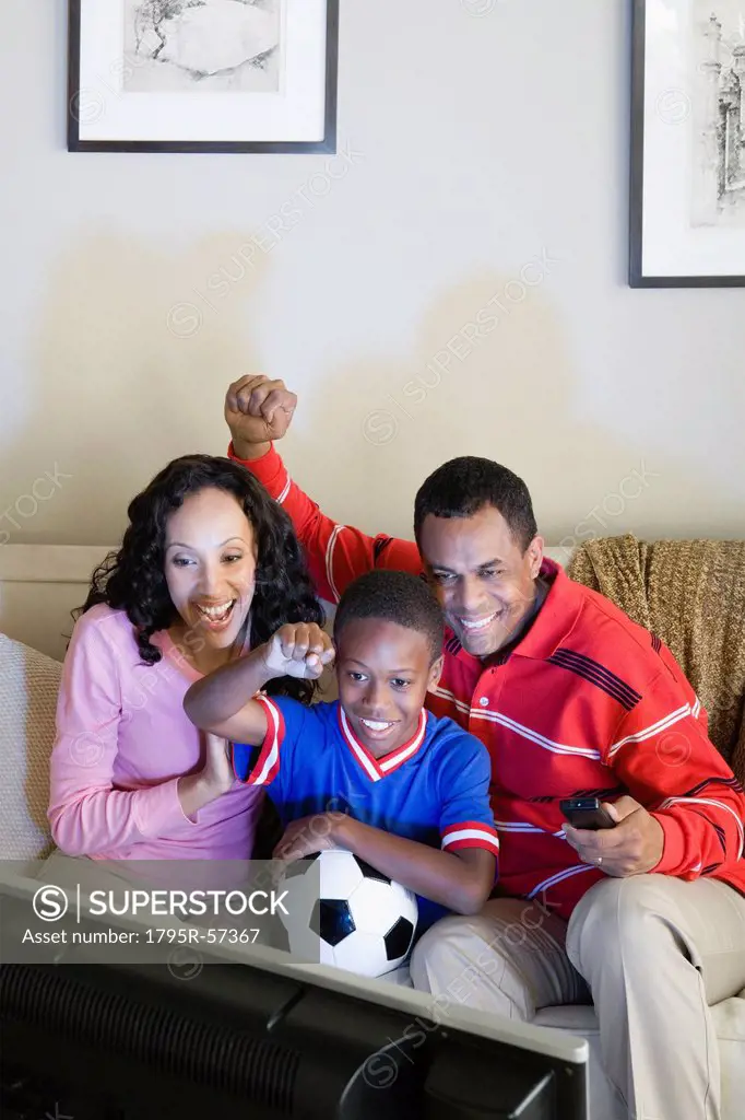 Parents with Son 12_13 watching sports on tv