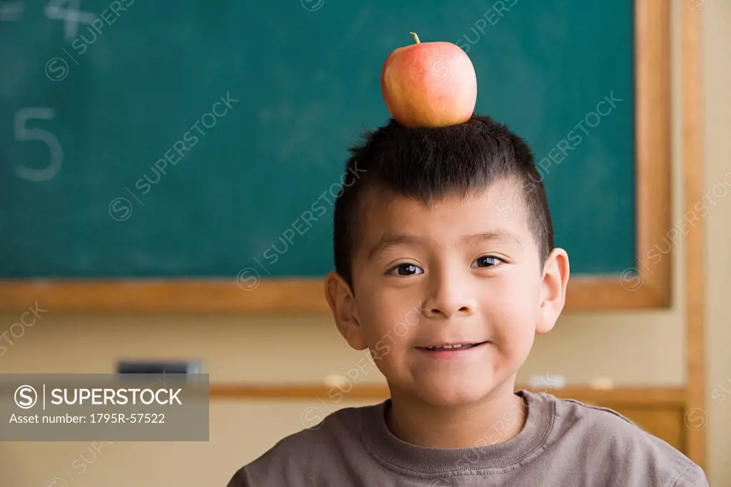 Boy 6_7 with apple on his head