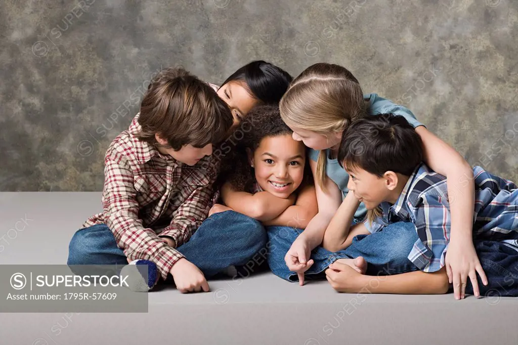 Children 6_7, 8_9 playing together, studio shot