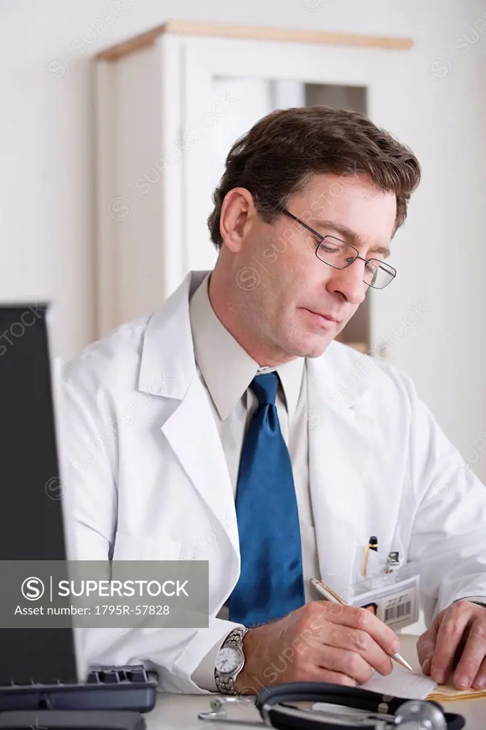 Male doctor working at desk