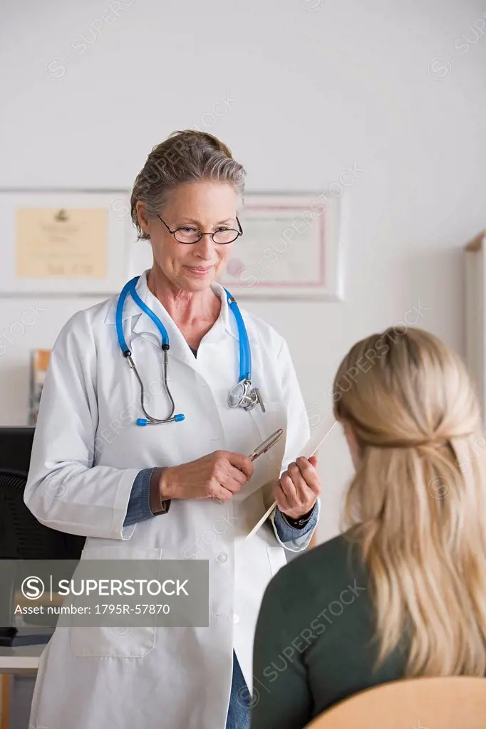 Female doctor talking to patient in her office