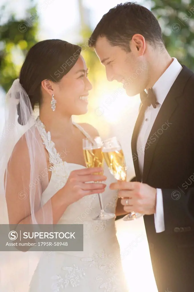 Bride and groom toasting with champagne