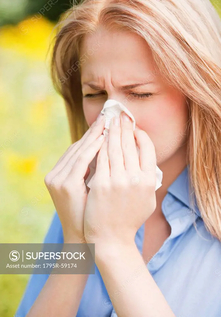 Close up of woman sneezing