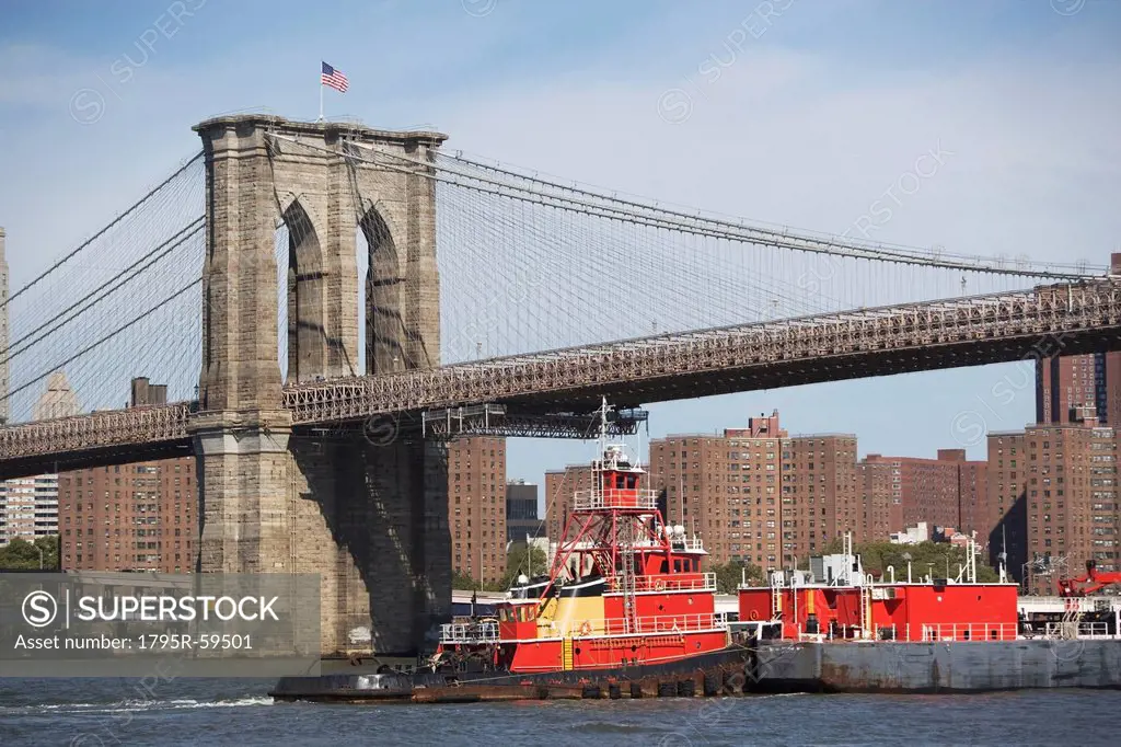 USA, New York State, New York City, Barge under Brooklyn Bridge