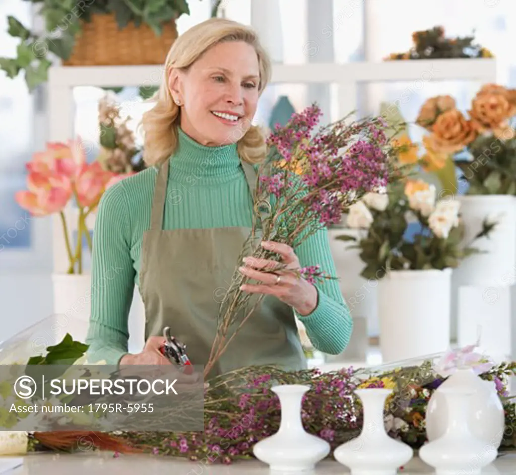 Female florist cutting flowers
