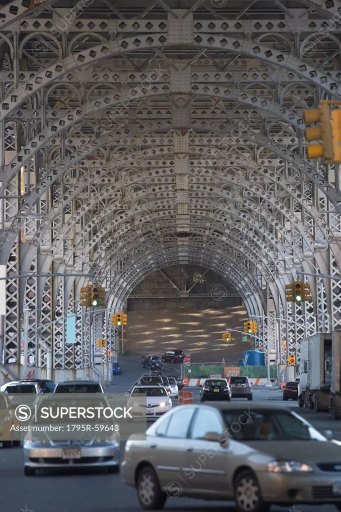 USA, New York City, Traffic passing under bridge