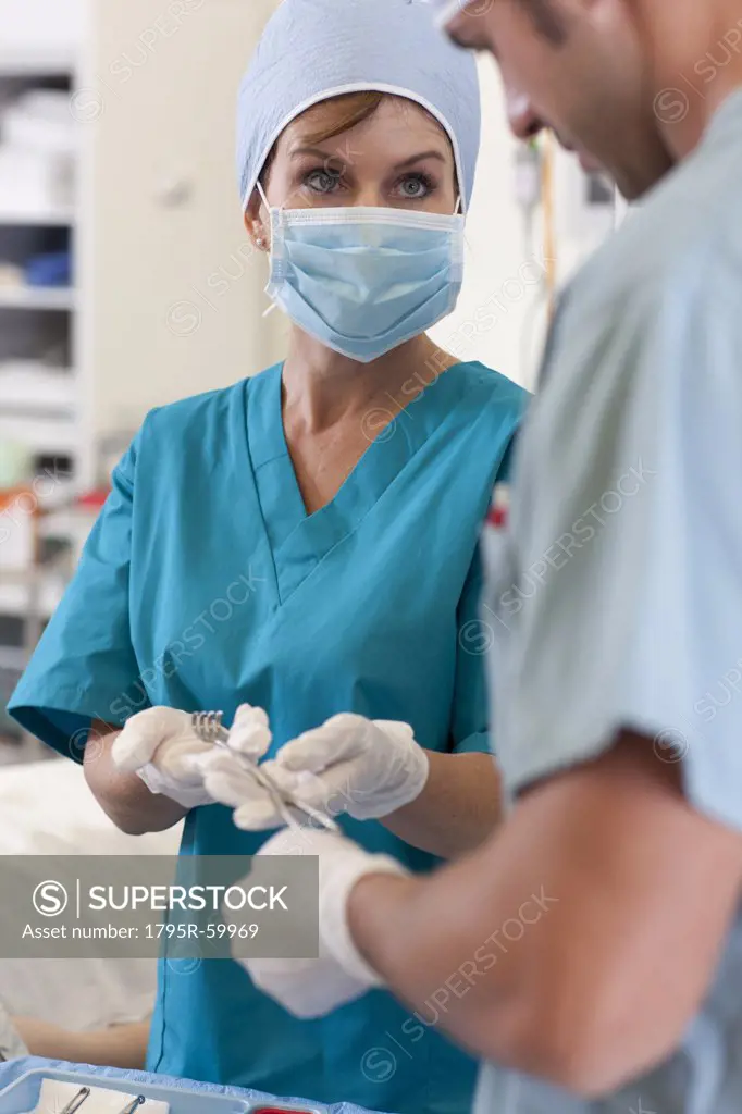 Surgeons holding tools