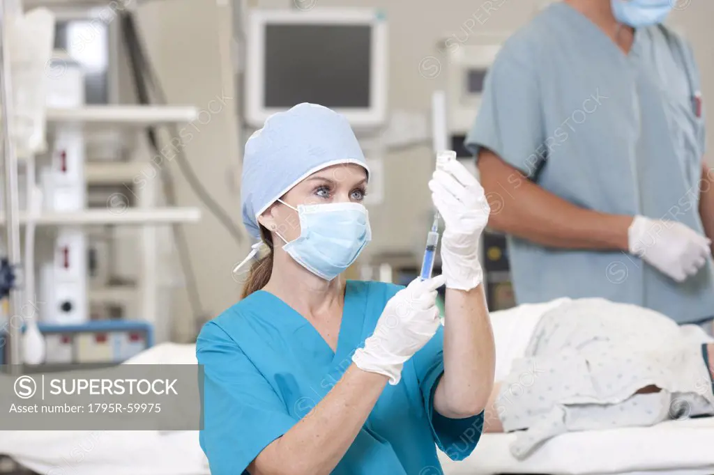 Surgeons preparing patient for surgery