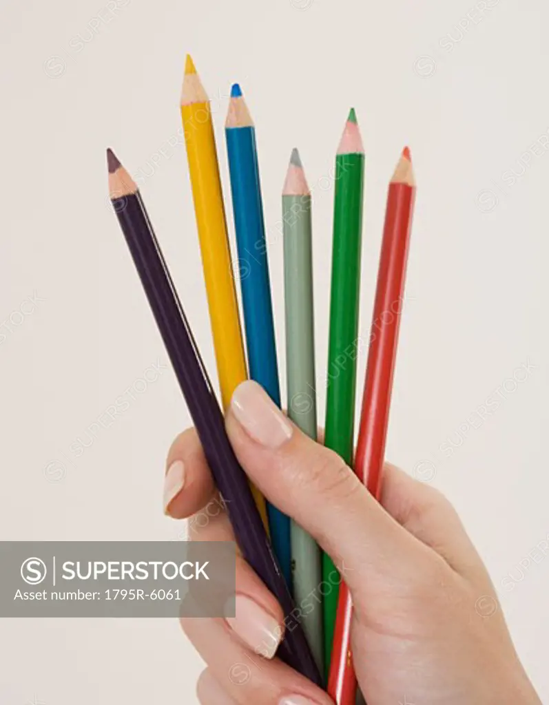 Close-up of woman holding colored pencils