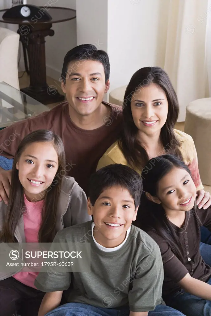 Portrait of happy family with three children (8-9, 10-11)