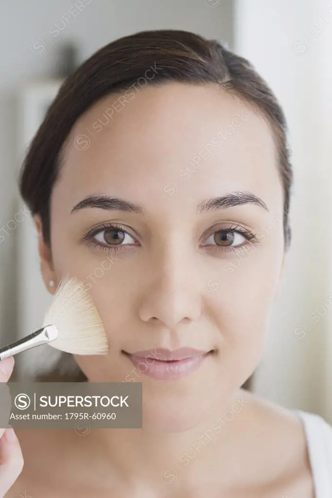 Woman applying make-up