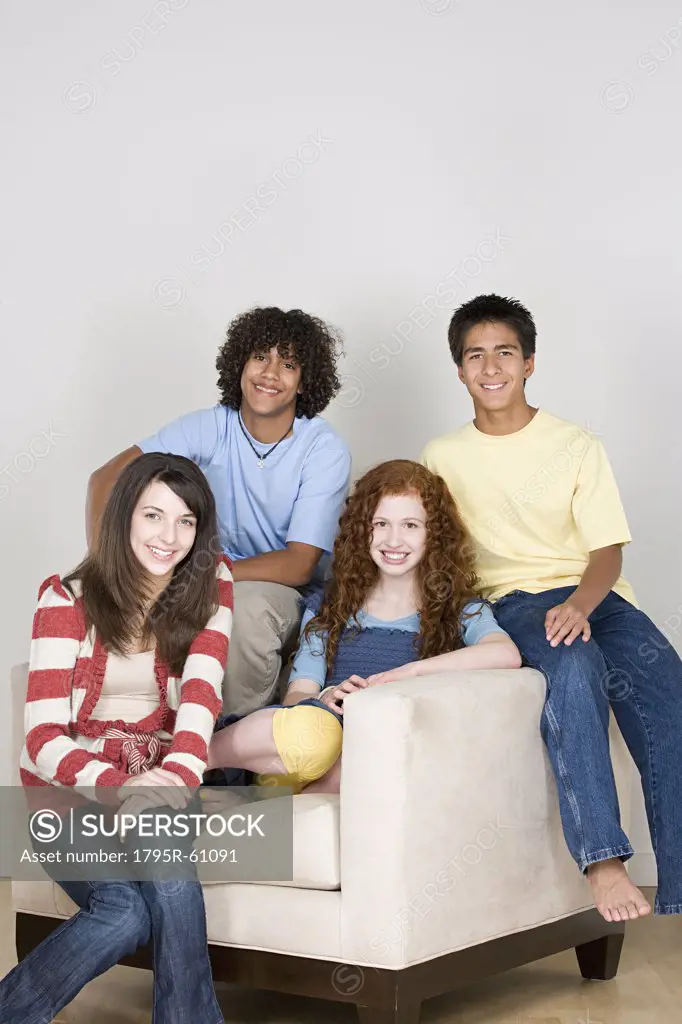 Portrait of teenagers (14-15,16-17) sitting on armchair