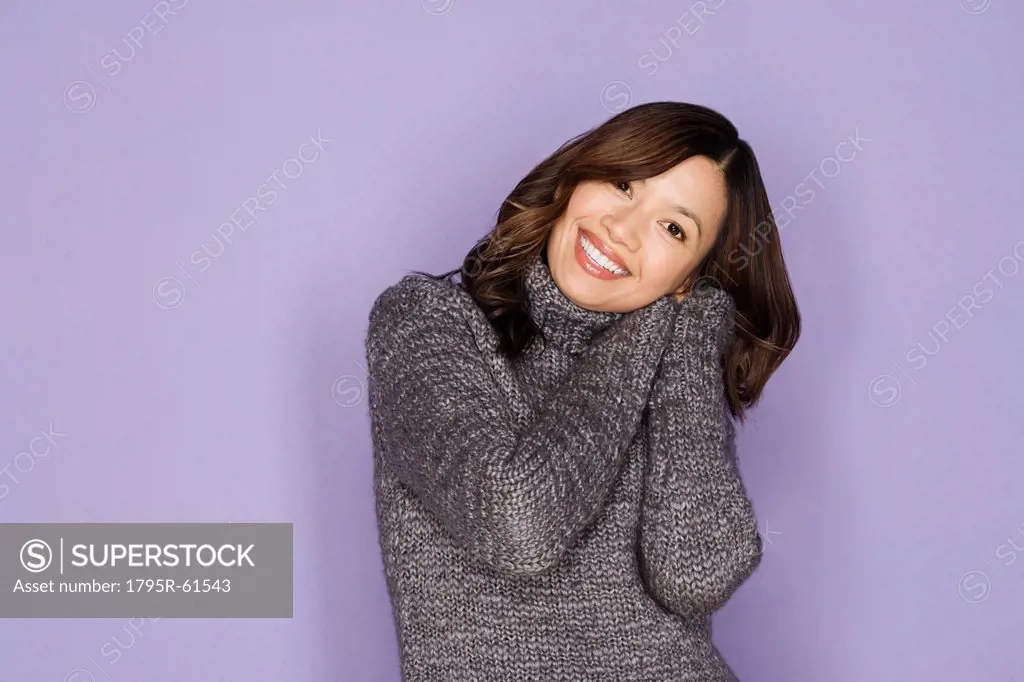 Portrait of happy asian woman wearing wooly jumper