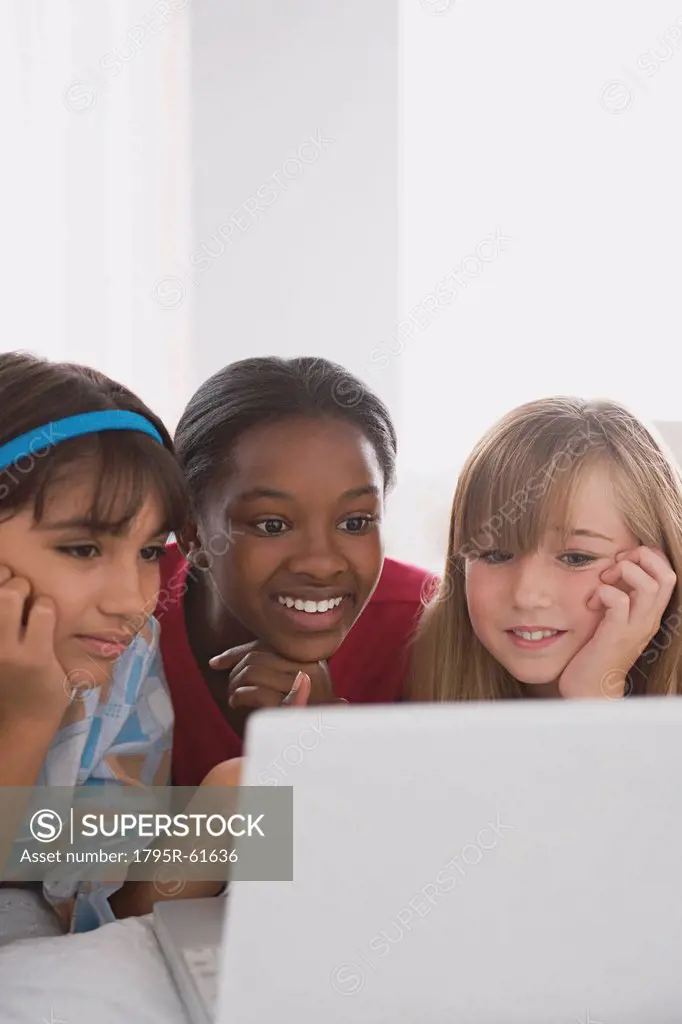Portrait of three girls 10_11 using laptop