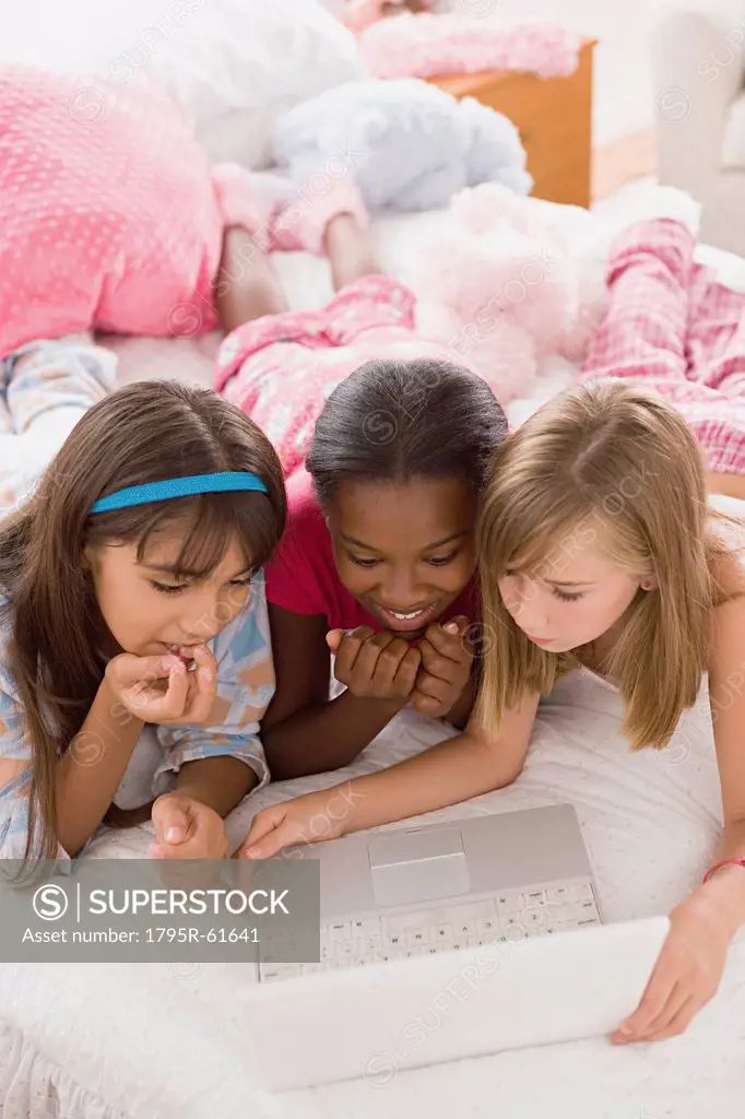 Portrait of three girls 10_11using laptop