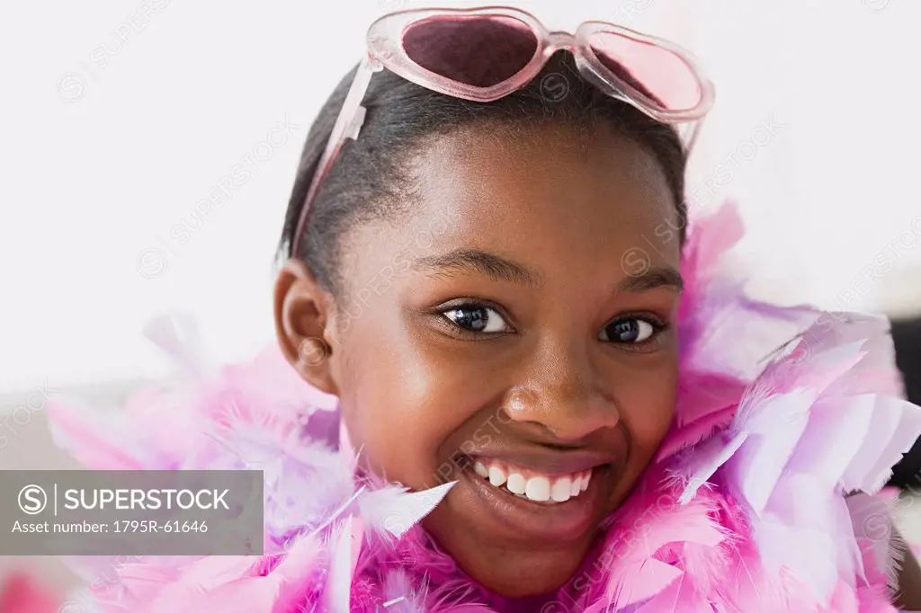Portrait of smiling girl 10_11 wearing feather boa and sunglasses