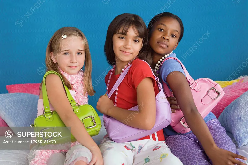 Portrait of three girls 10_11 wearing colorful purses
