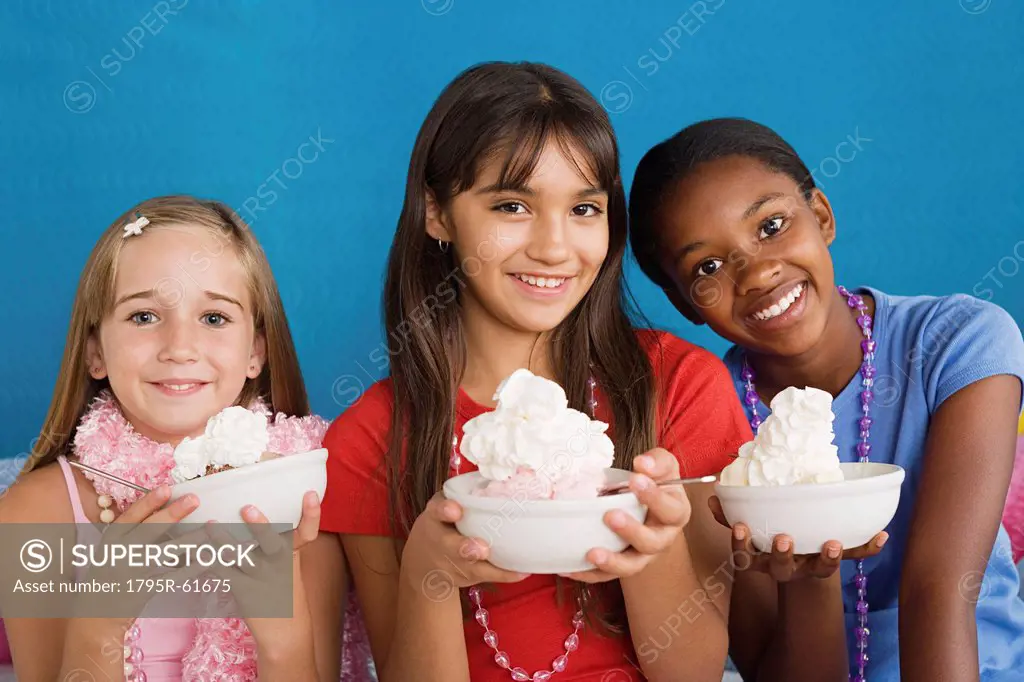 Portrait of three girls 10_11 holding desserts