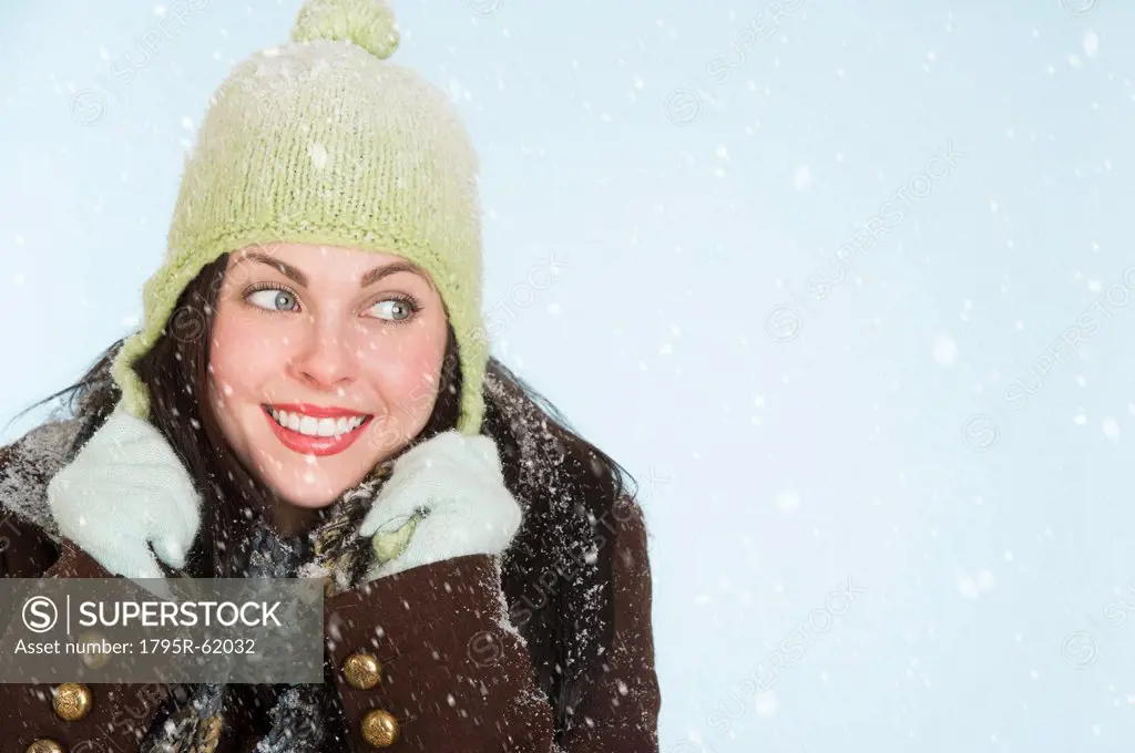 Studio portrait of woman in winter clothing