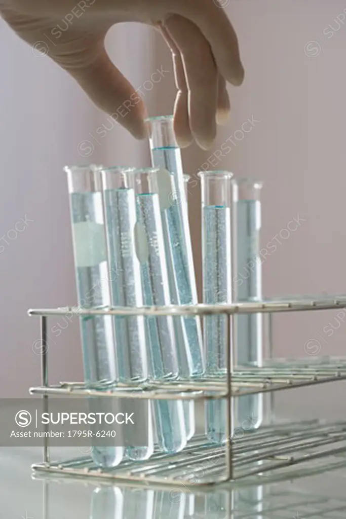 Scientist taking vial out of rack