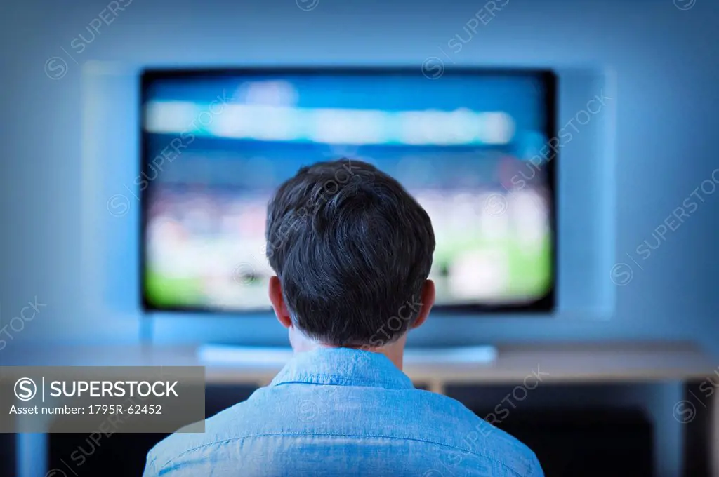 Man watching tv in living room