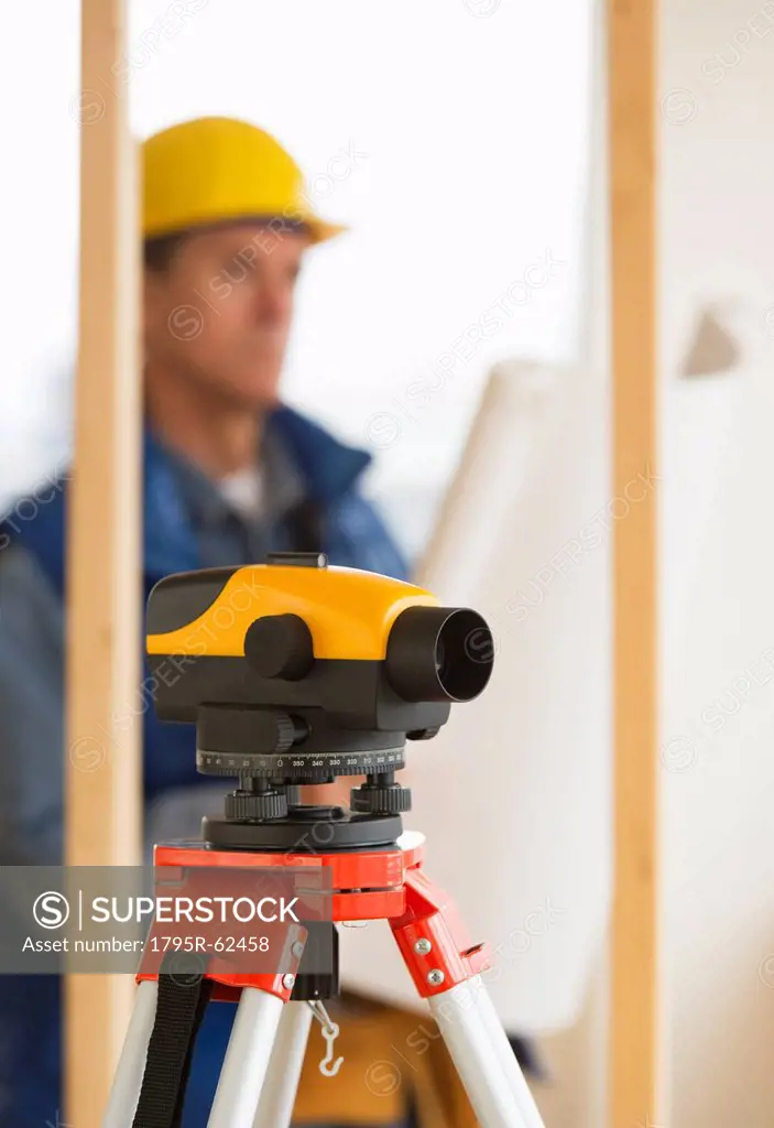 Construction worker with theodolite