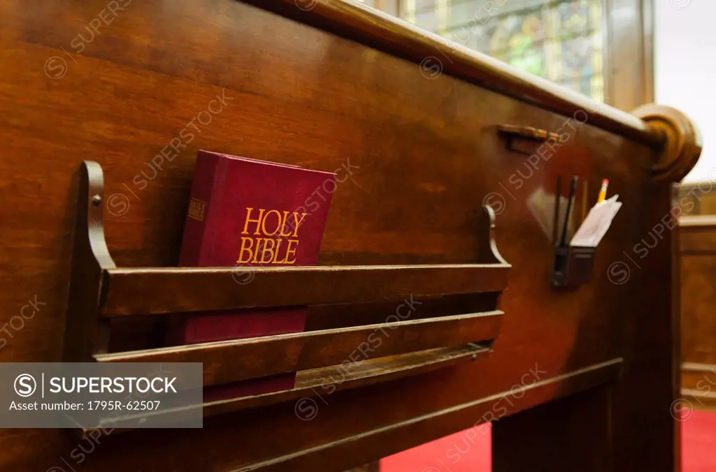 Close up of bible on wooden church pew