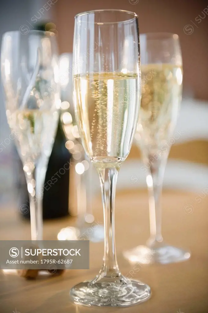 Champagne flutes and cork on table
