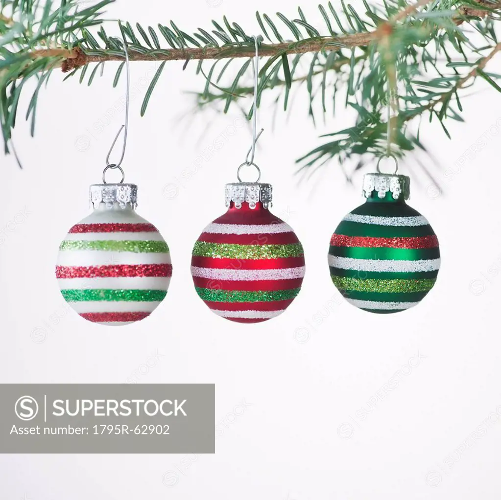 Studio shot of striped Christmas ornaments hanging on Christmas tree