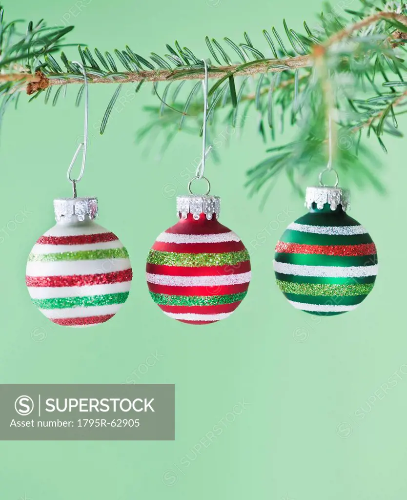 Studio shot of striped Christmas ornaments hanging on Christmas tree