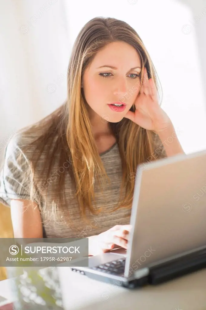 Portrait of young woman working with laptop