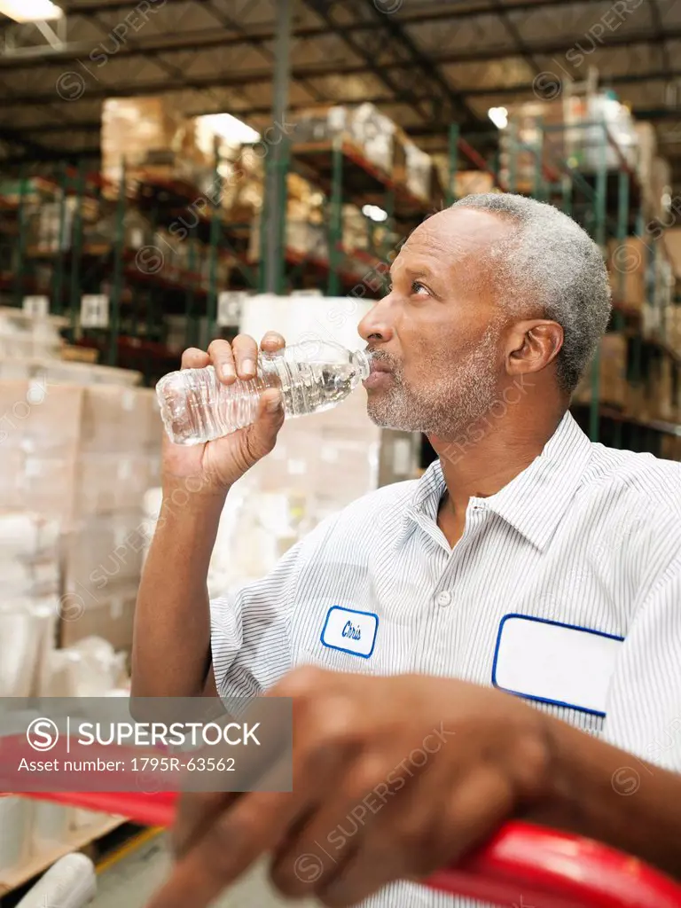 Warehouse worker drinking water