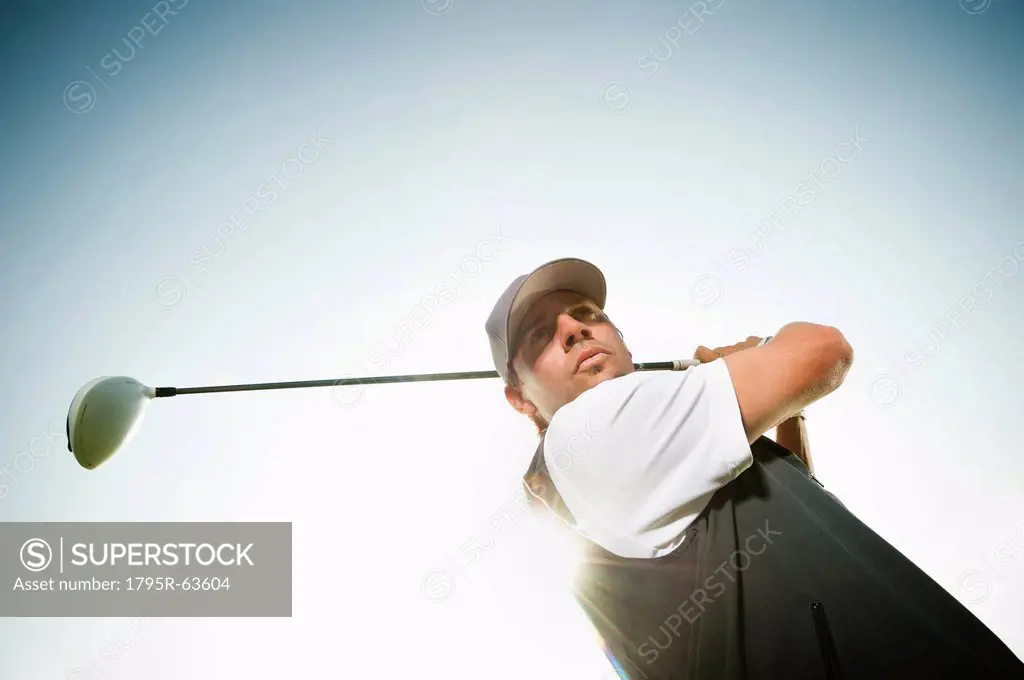 Low angle view of man playing golf