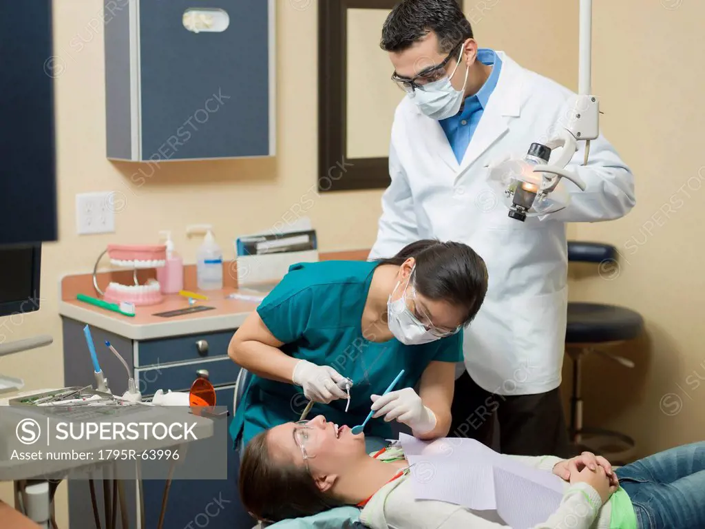 Dentists and patient in dental surgery