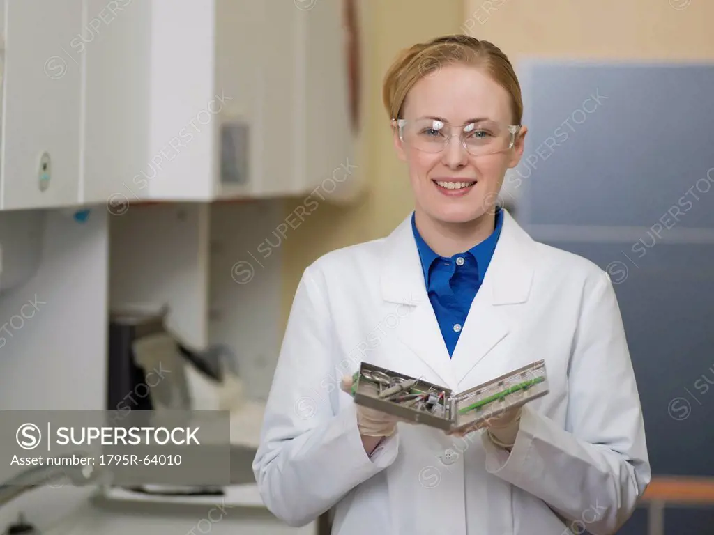 Portrait of dentist holding dental tools