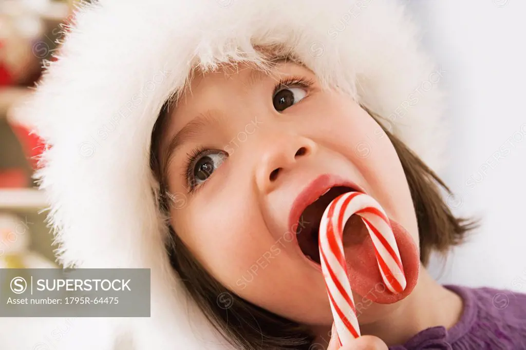 Close_up of girl 10_11 licking candycane