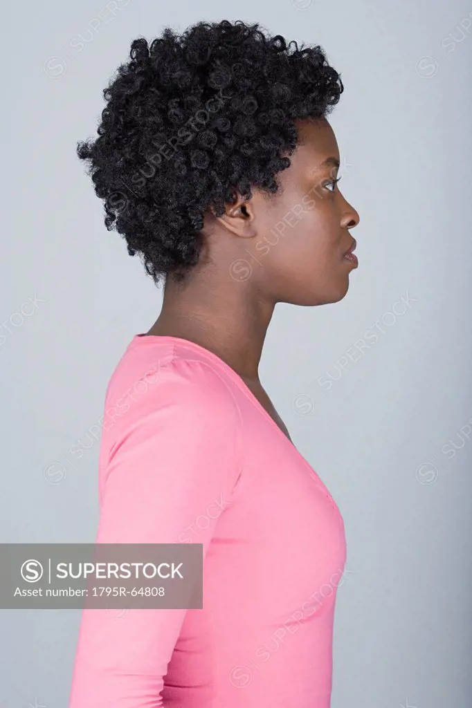 Studio shot portrait of mid adult woman, side view
