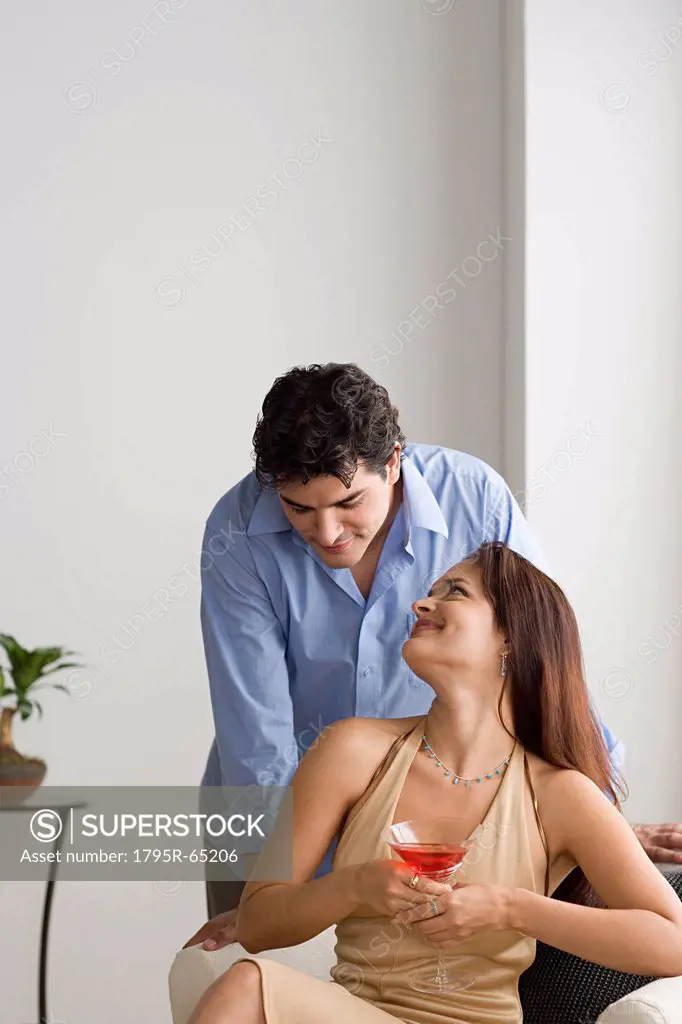 Happy couple together, woman holding cocktail