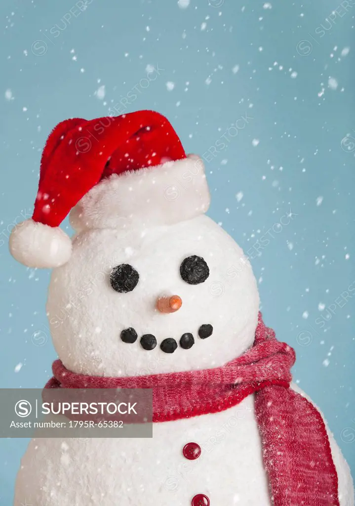Studio shot of snowman wearing Santa hat