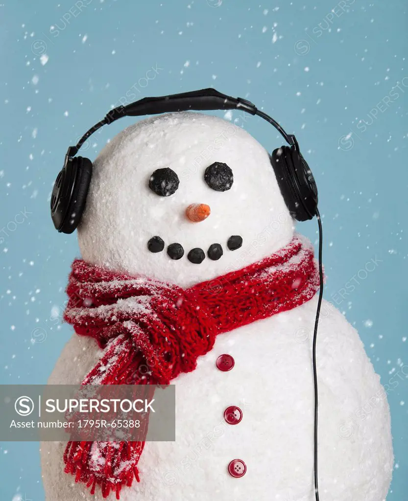 Studio shot of snowman wearing headphones
