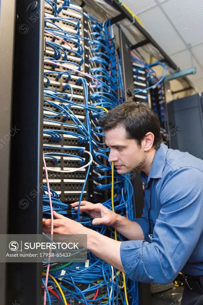 Technician inspecting network server