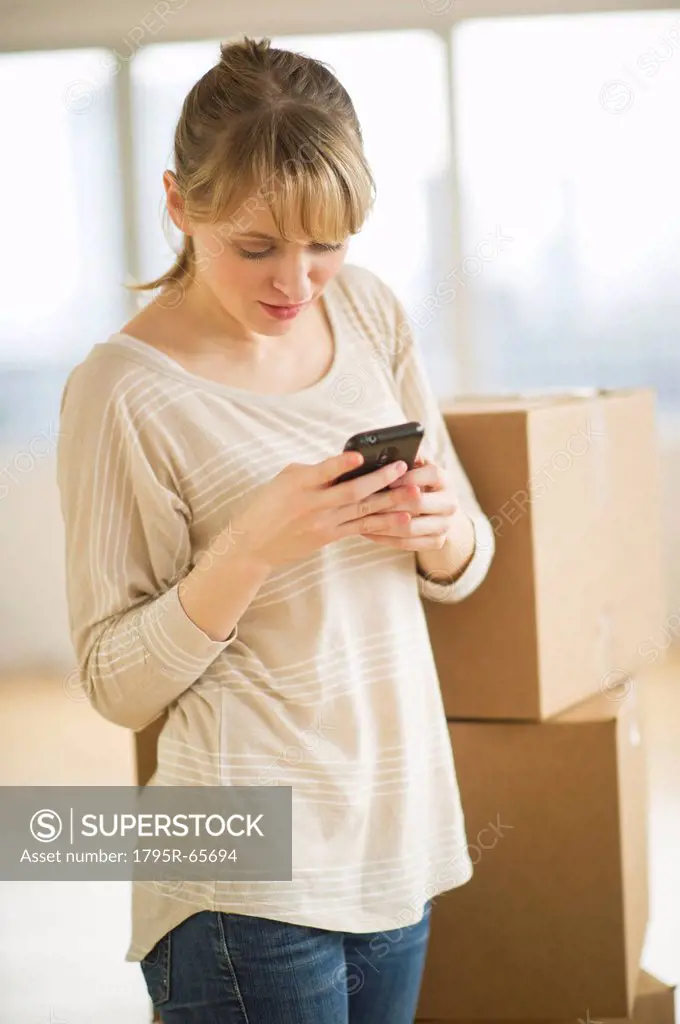 Woman using smart phone during relocation