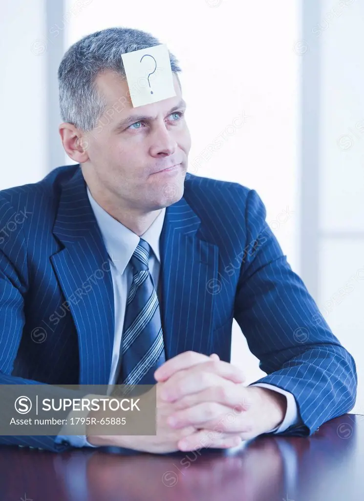 Portrait of businessman with label on forehead
